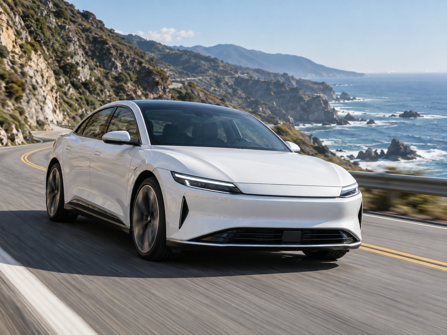 White electric car on a coastal road